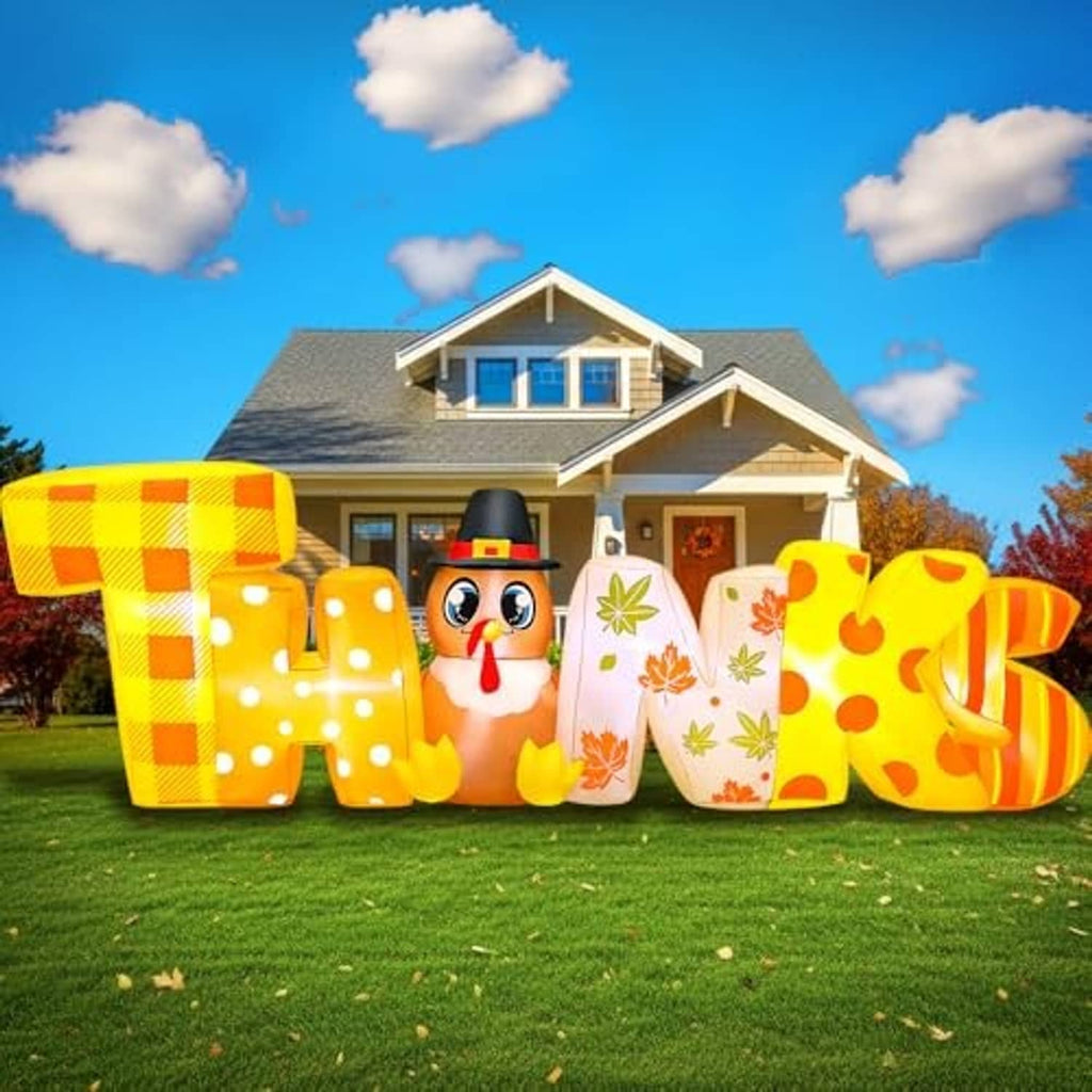 Daytime view of glowing Thanksgiving inflatable letters with turkey face and leaf patterns