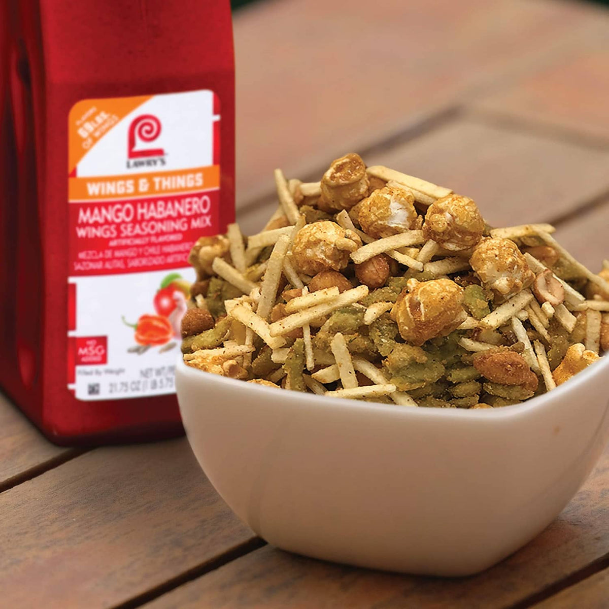 Lawry's Mango Habanero Wings Seasoning Mix bottle with bowl of seasoned wings