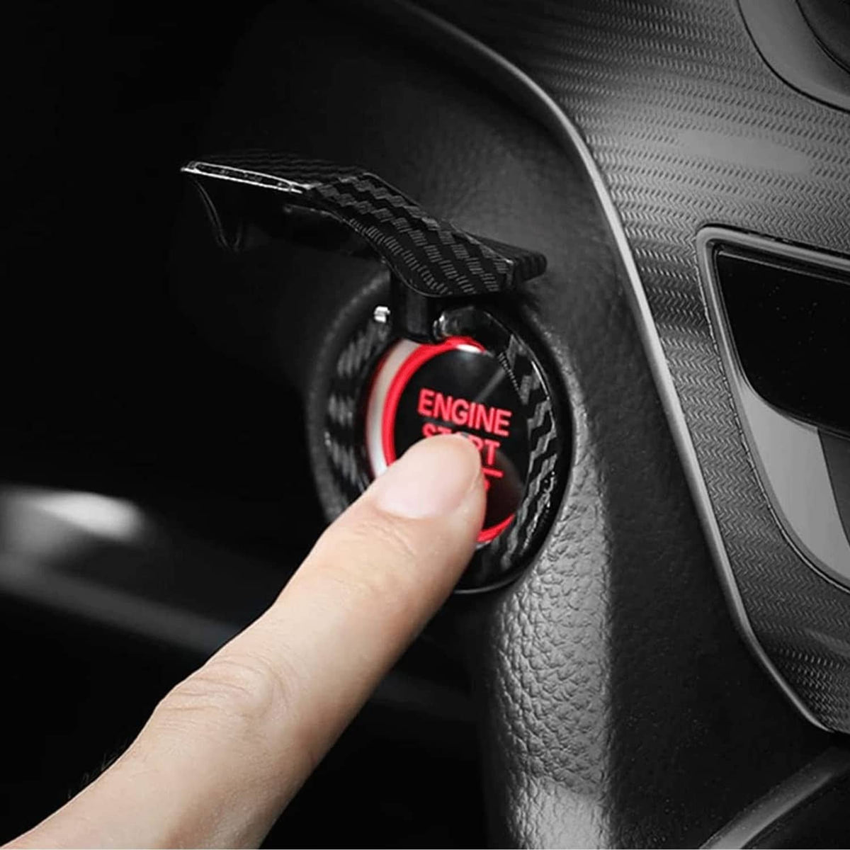 Carbon fiber engine start/stop button cover installed on console next to steering trim