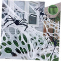 Outdoor Halloween spider web decoration with large white webbing and black crawling spiders
