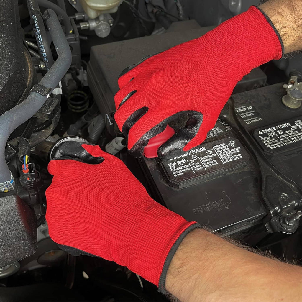 Nitrile-coated orange work gloves on a mechanic hand working near vehicle parts