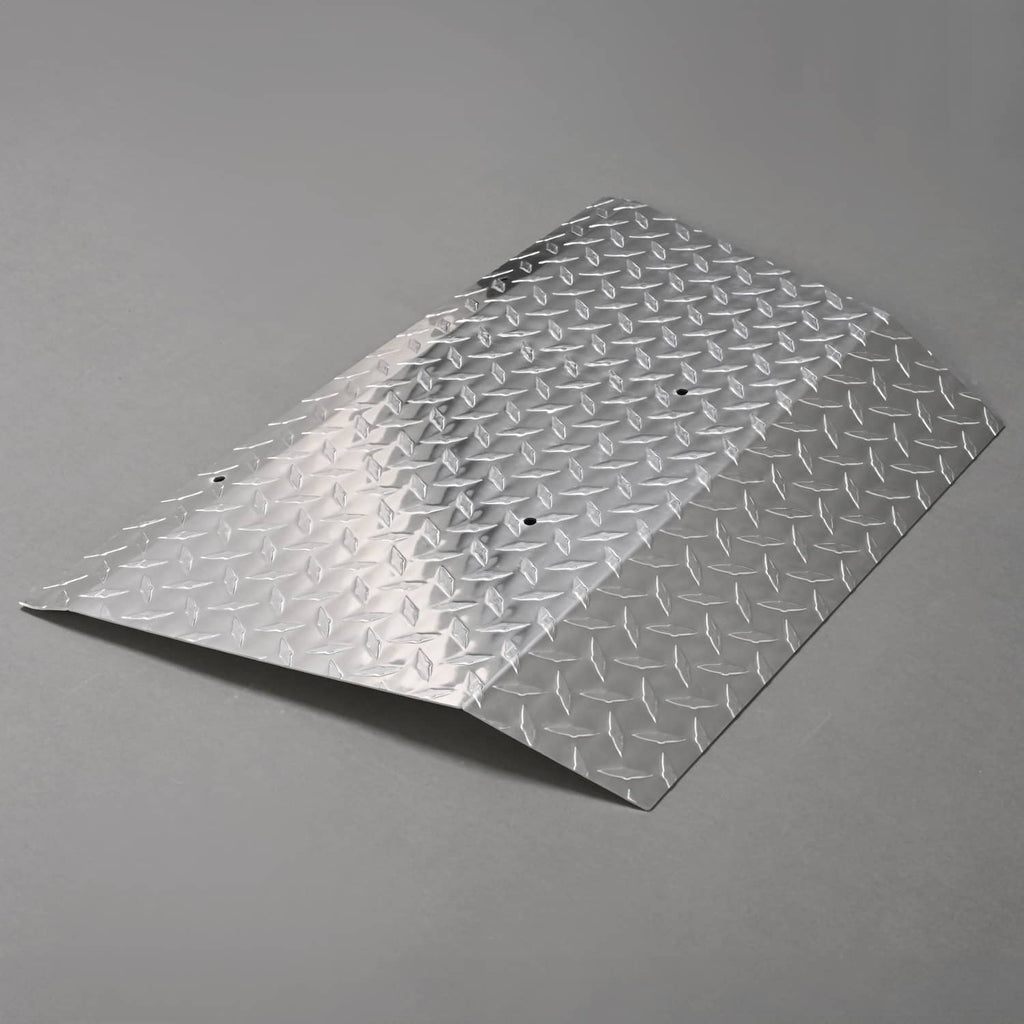 Aluminum diamond plate bumper cover with embossed surface and visible mounting holes