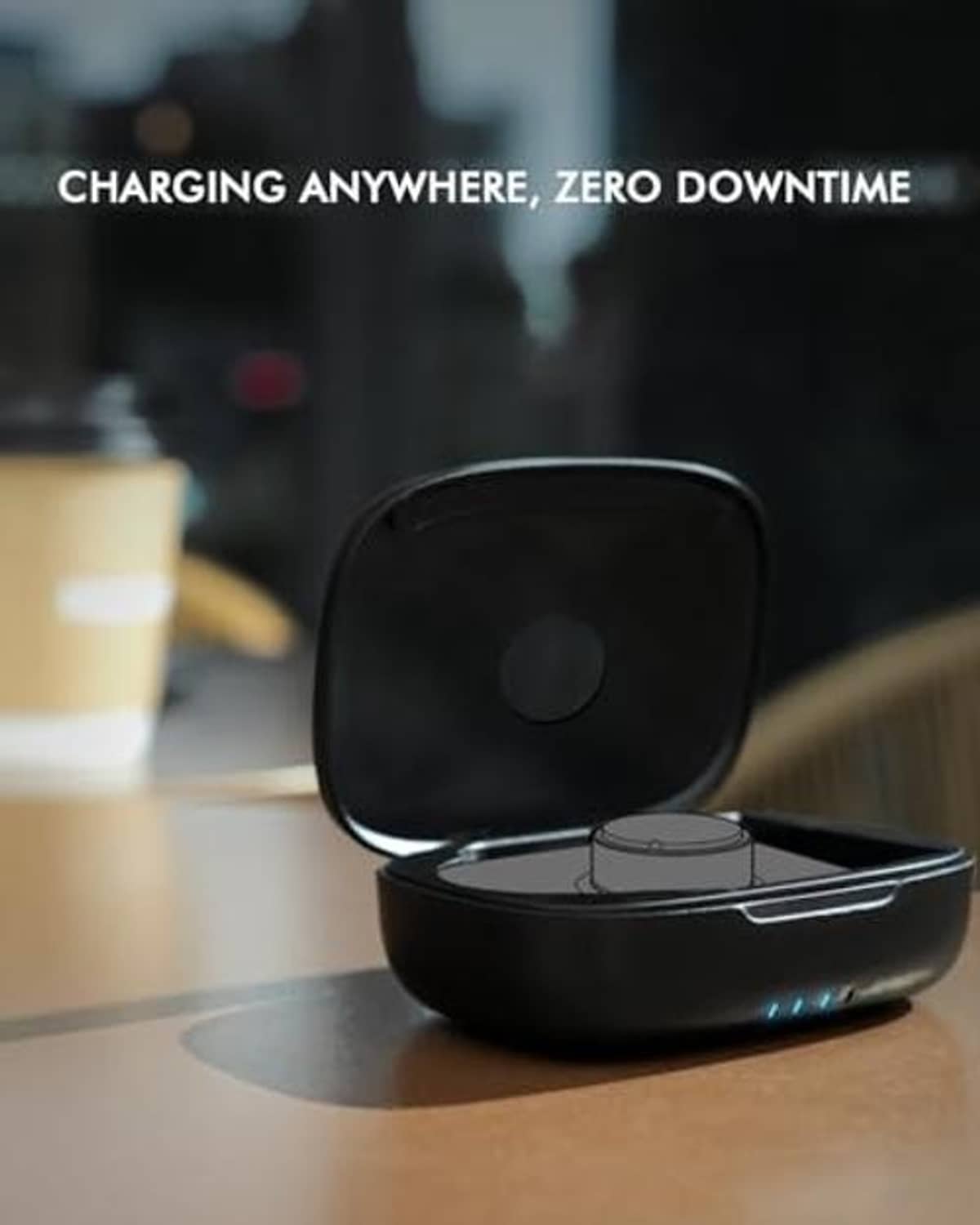 Black charging case on tabletop with lid open, showing the charging cradle