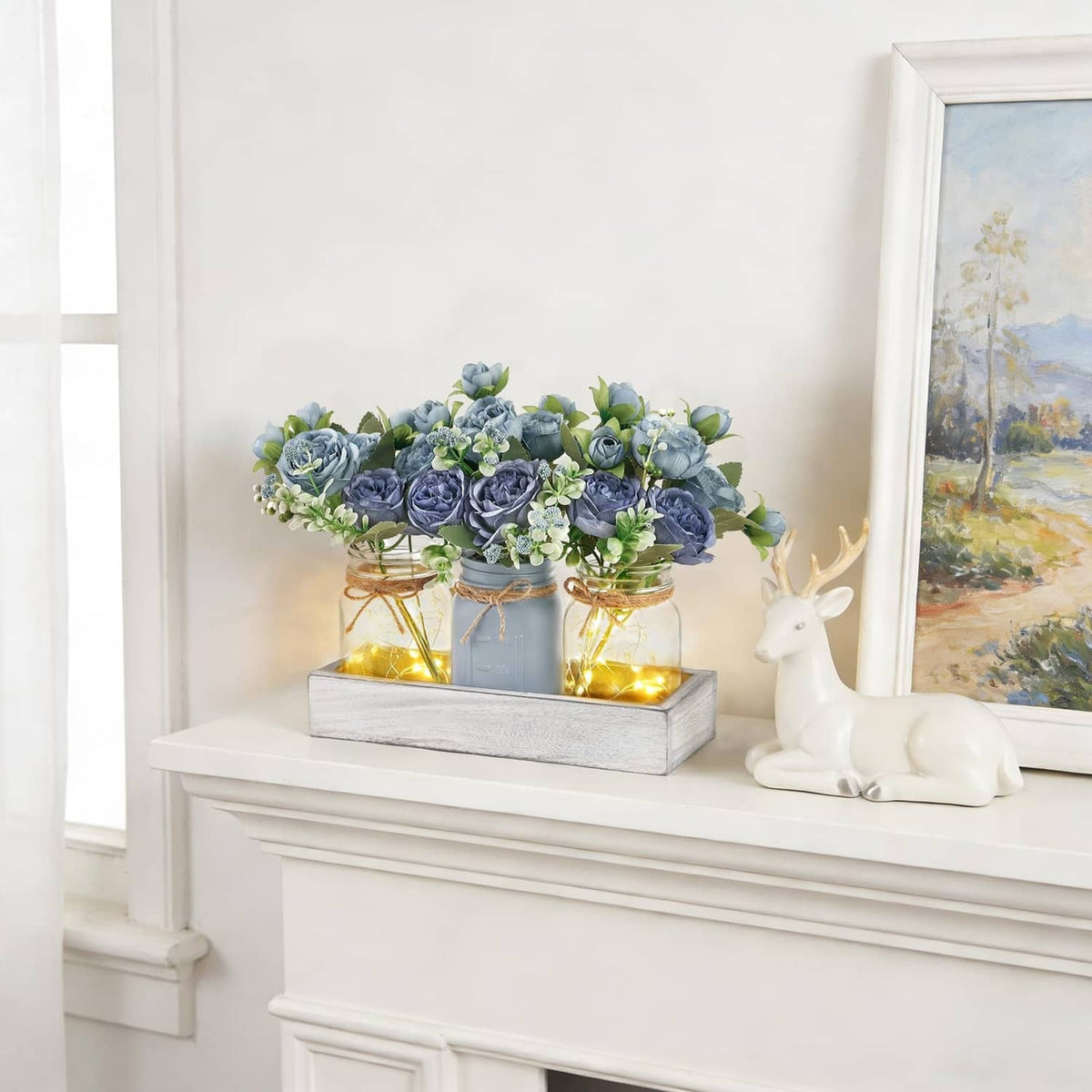 Blue rose mason jar light centerpiece with glowing jars in grey tray on console table