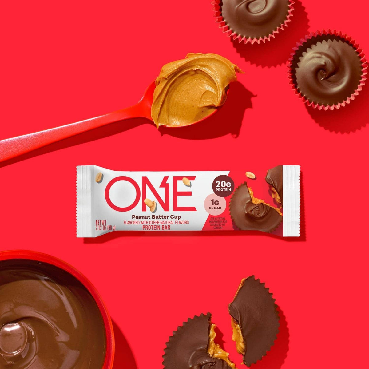 ONE peanut butter cup protein bar with chocolate coating and peanut topping, unwrapped.