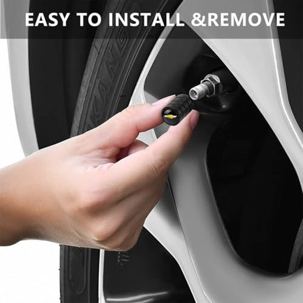 Black textured tire valve stem cap being installed on a car wheel valve