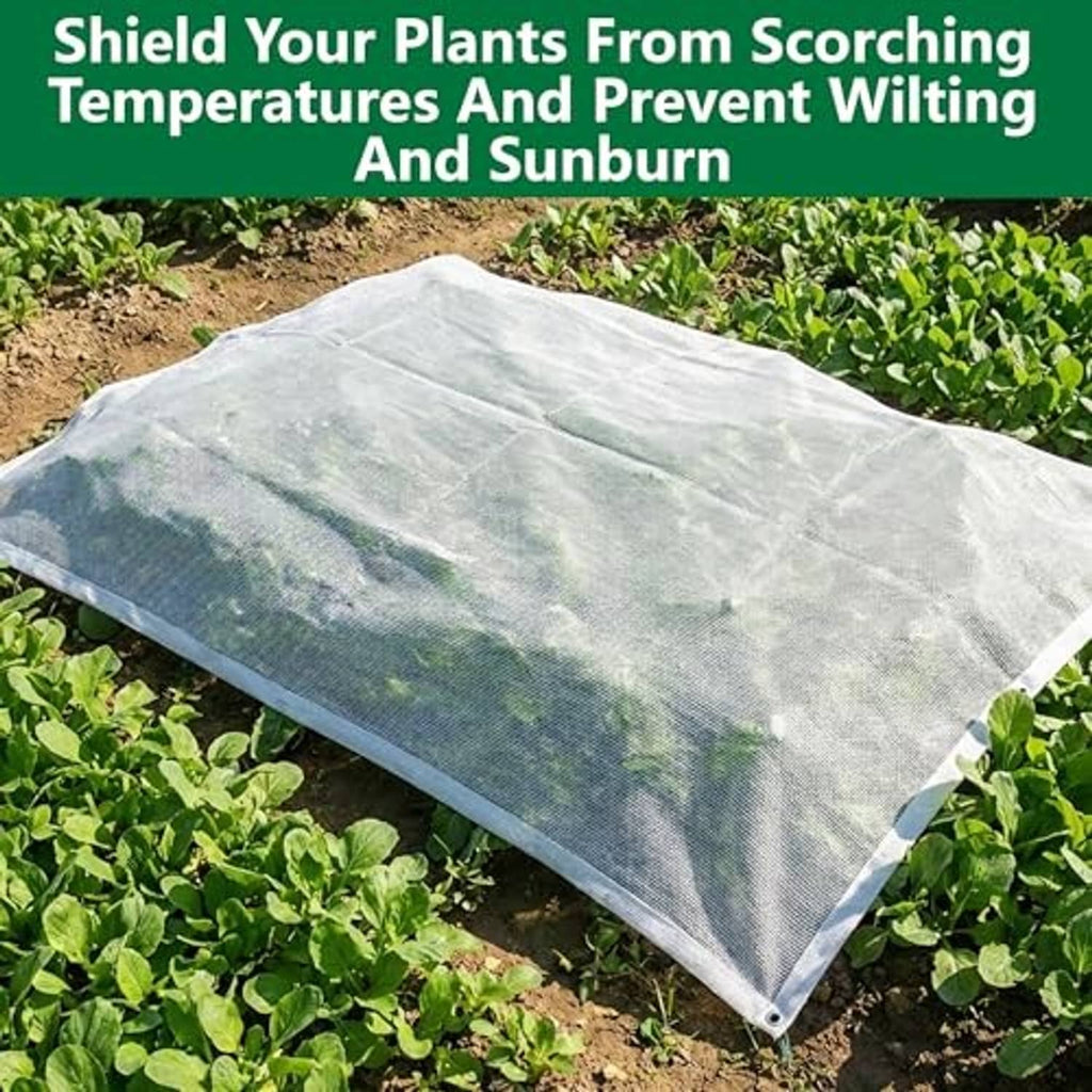 White plant sun shade cloth laid over garden plants, lightweight mesh cover