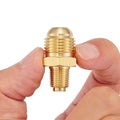Brass propane orifice connector with flare and MNPT threads, close-up with fingers
