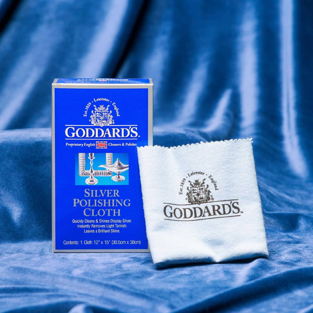 Silver polishing cloth folded with Goddards logo beside product box