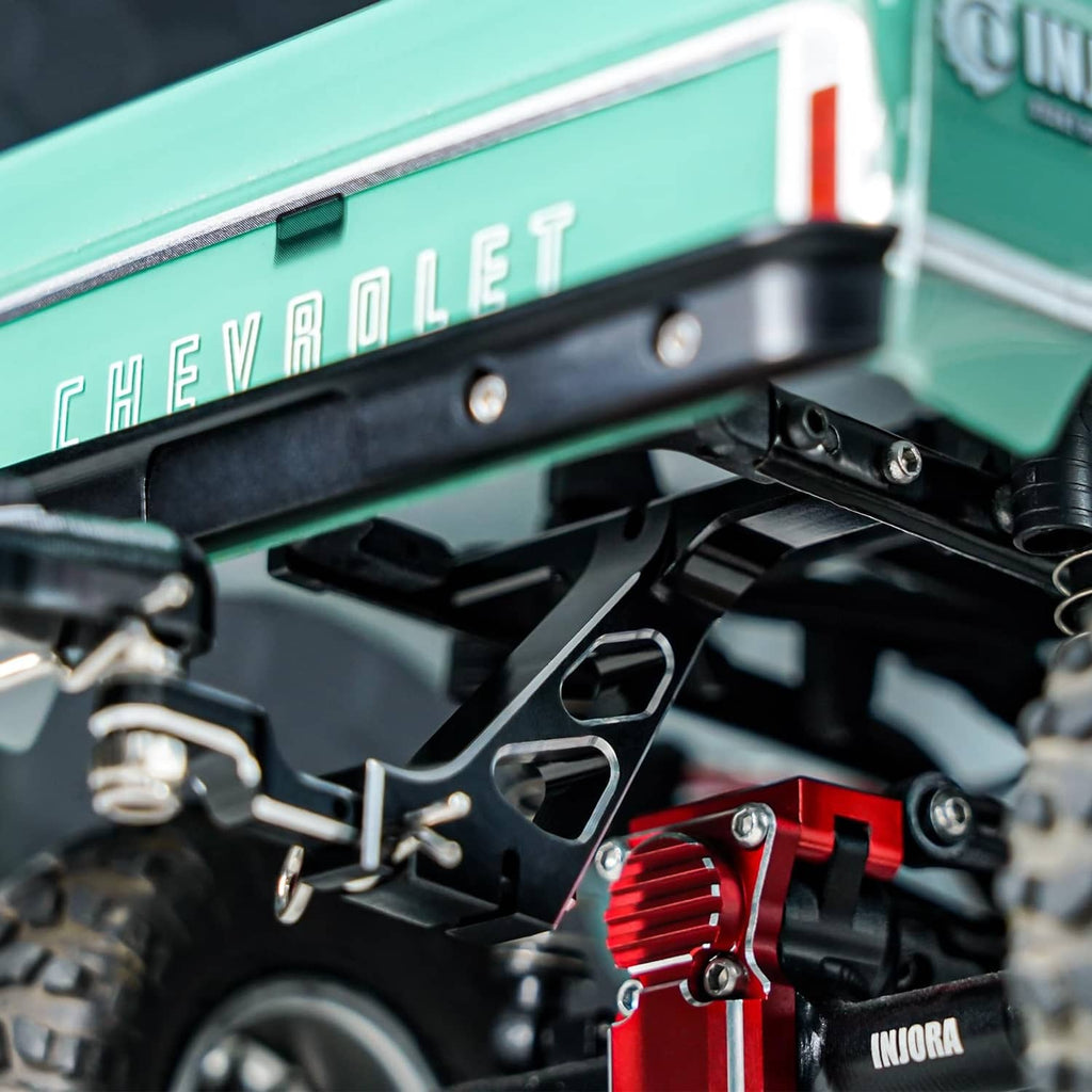 Black RC trailer hitch mount with metal bracket, bolts, and mounting hardware