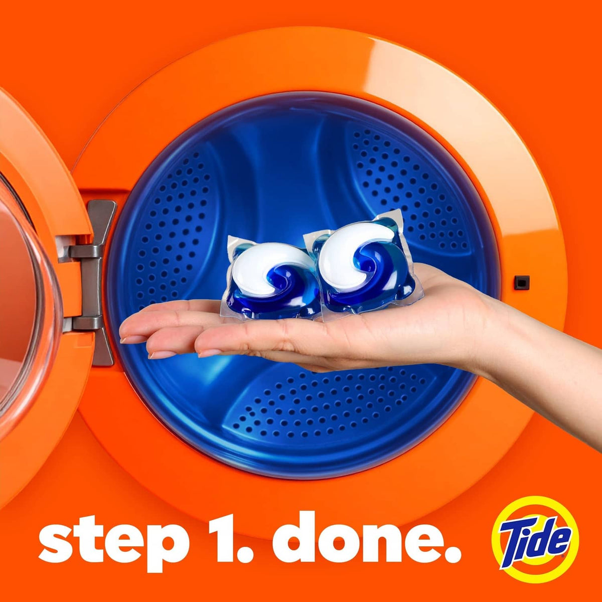 Laundry detergent pods held over washing machine drum, Tide logo