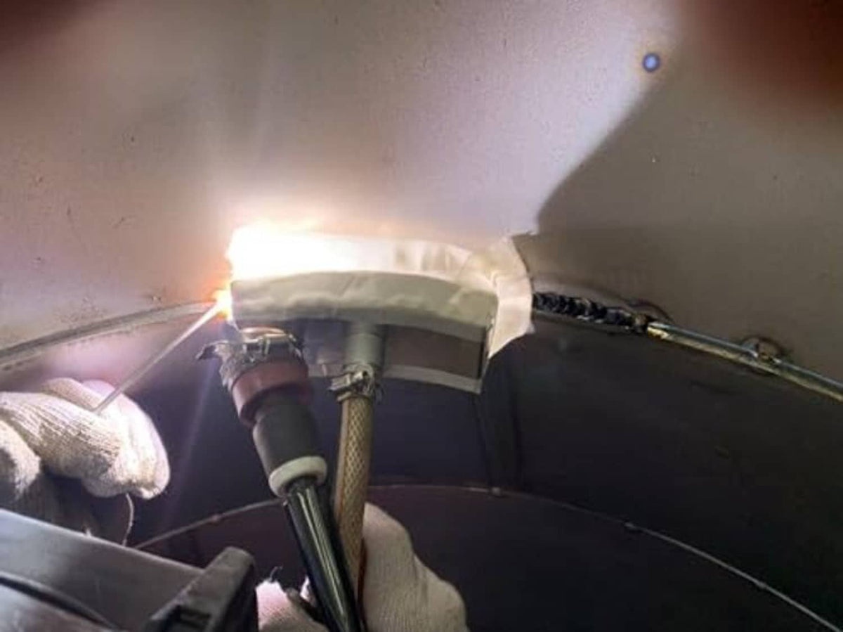 TIG welding trailing shield in use with protective cup over weld area