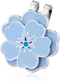 Blue flower-shaped magnetic golf ball marker with silver clip, close-up