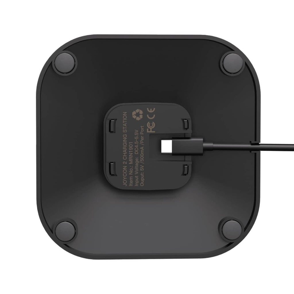 Bottom view of black Joy-Con charging dock with label panel and cable connection