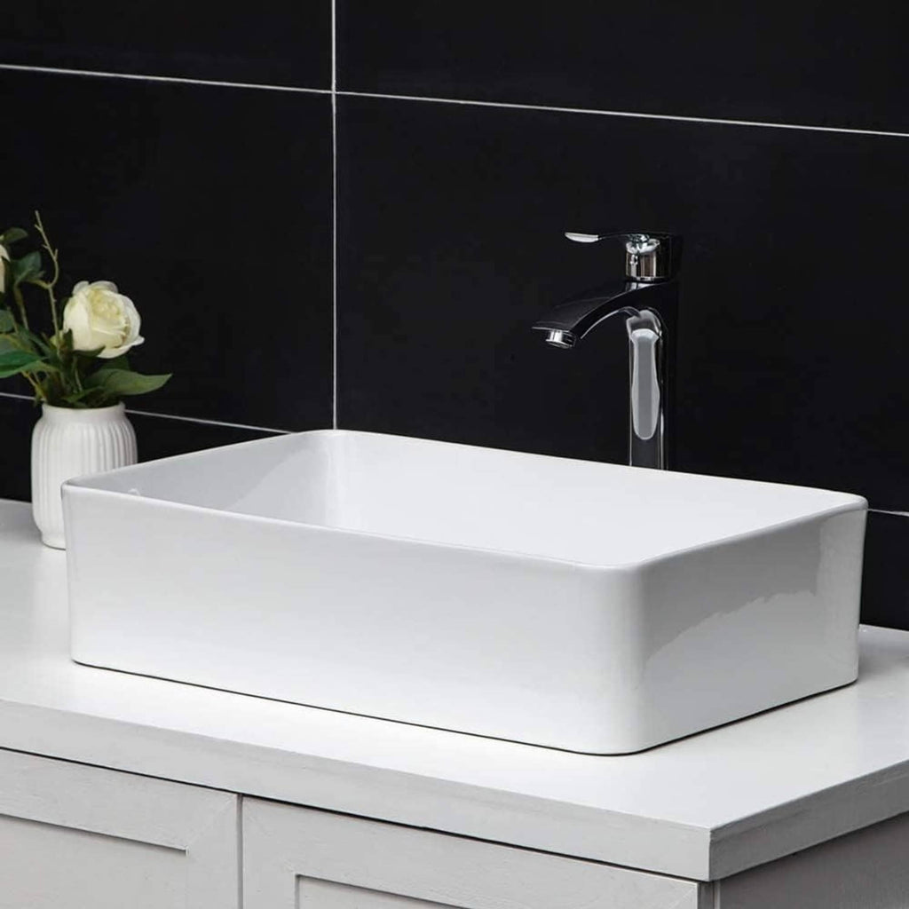 White rectangular vessel sink with chrome faucet, wide basin and visible drain hole