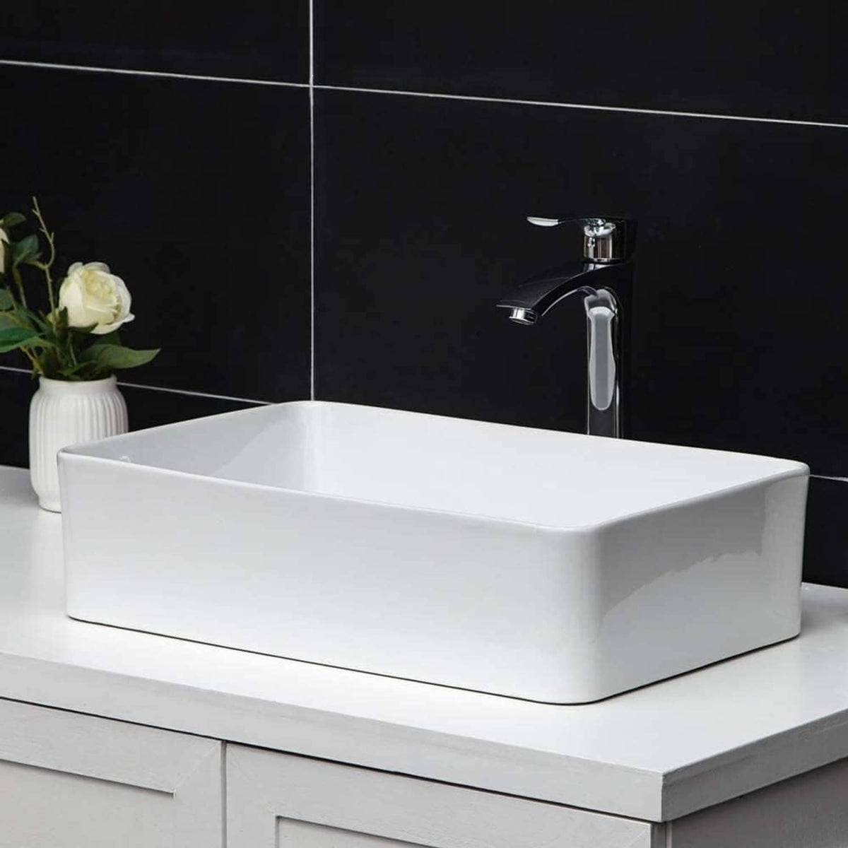 White rectangular vessel sink with chrome faucet, wide basin and visible drain hole