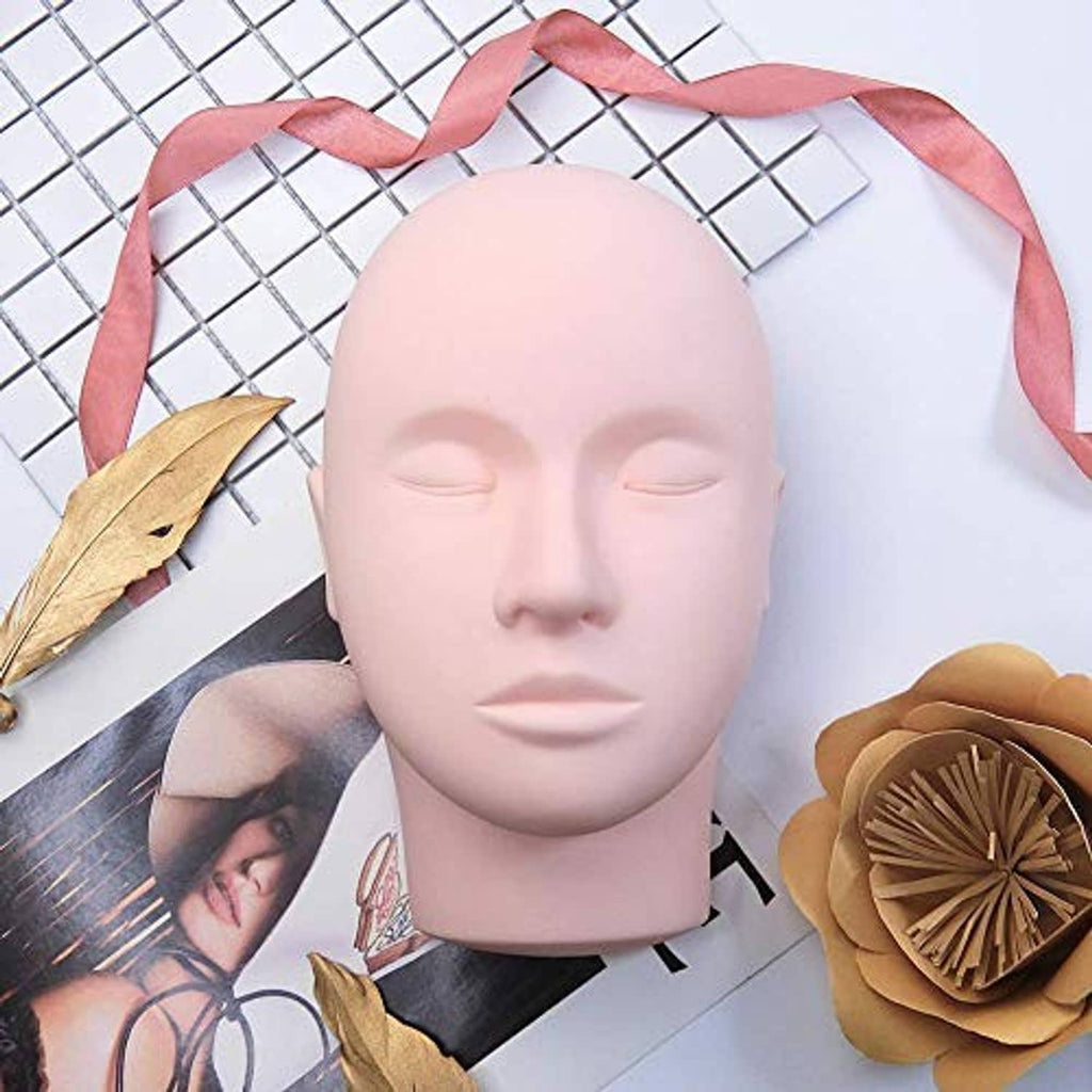 Beige lash training mannequin head with closed eyes and pink satin ribbon