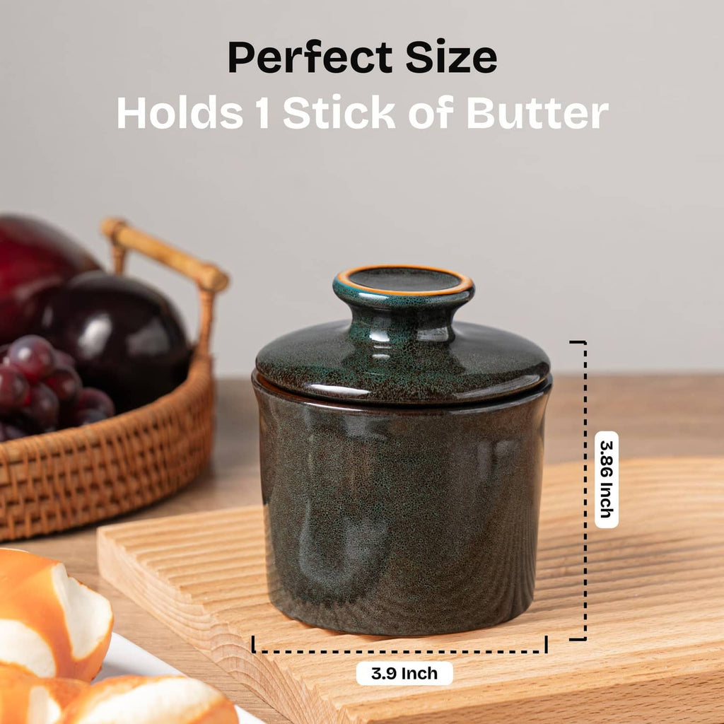 Greenish-brown butter crock with lid on a wooden surface, size reference shown