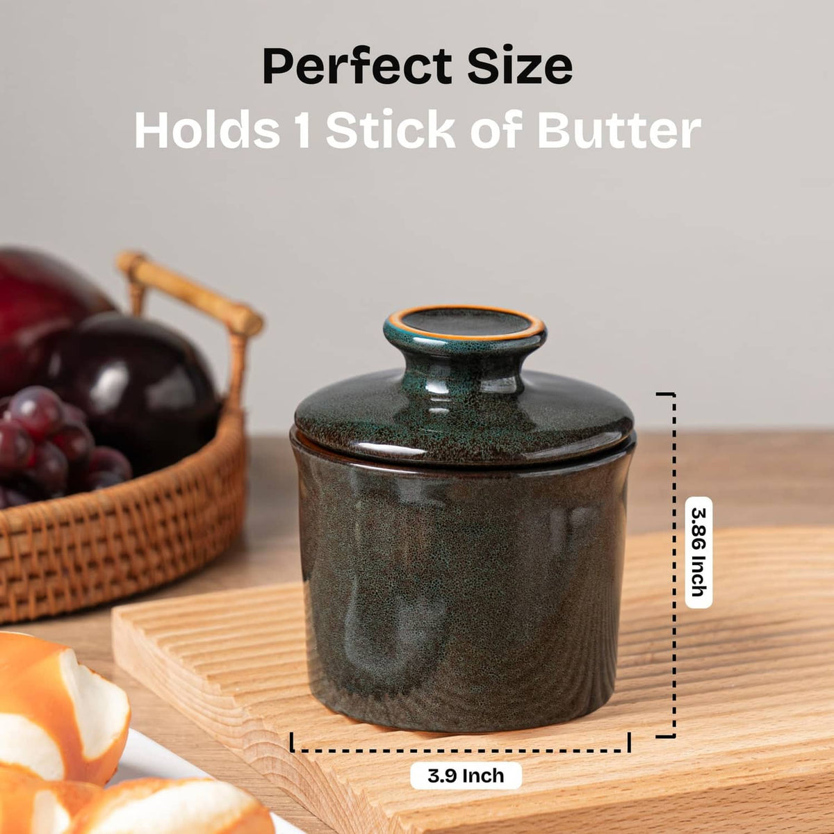 Greenish-brown butter crock with lid on a wooden surface, size reference shown