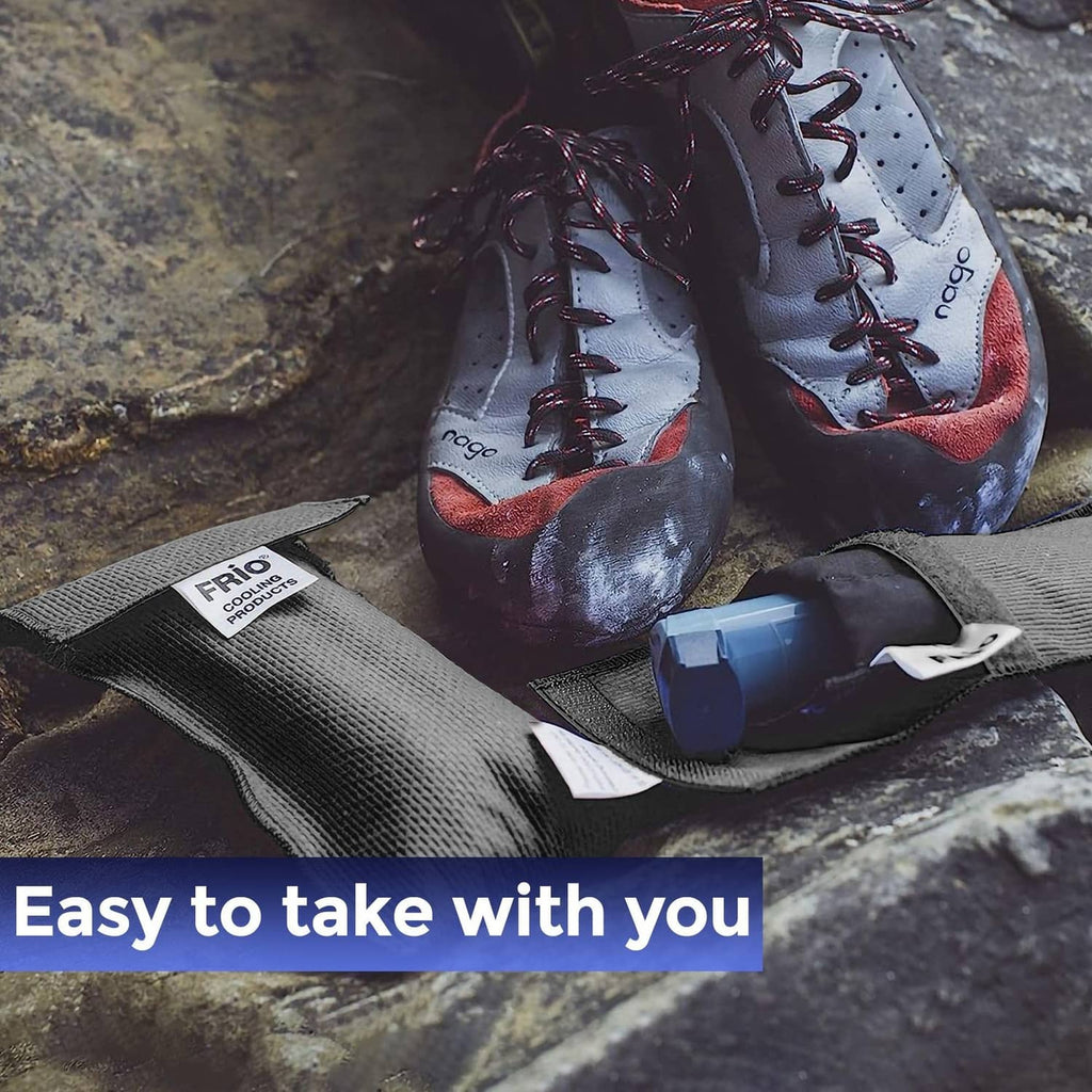 Black FRIO cooling wallet pouch with blue cooling block on stone surface