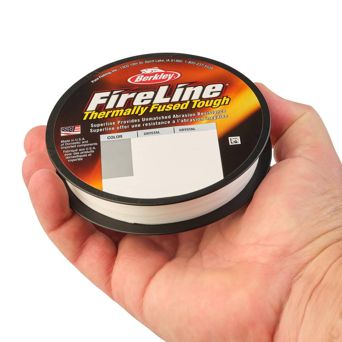 Berkley FireLine thermally fused tough line spool held in hand, white braided line