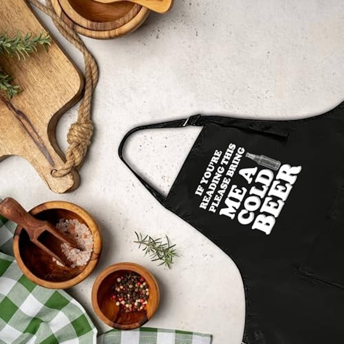Black apron with 'me a cold beer' slogan and front pocket
