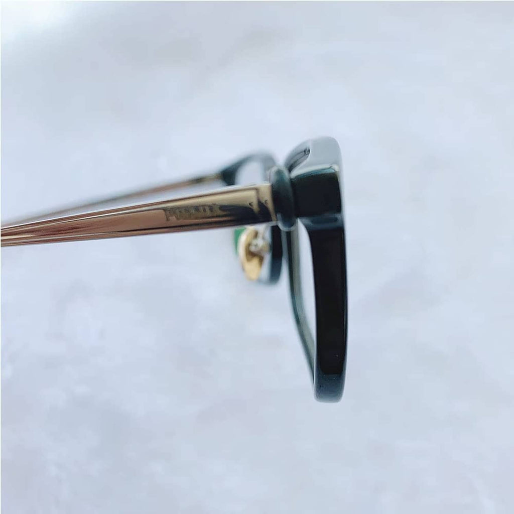 Eyeglass hinge tightener, black hinge clamp with gold screw detail