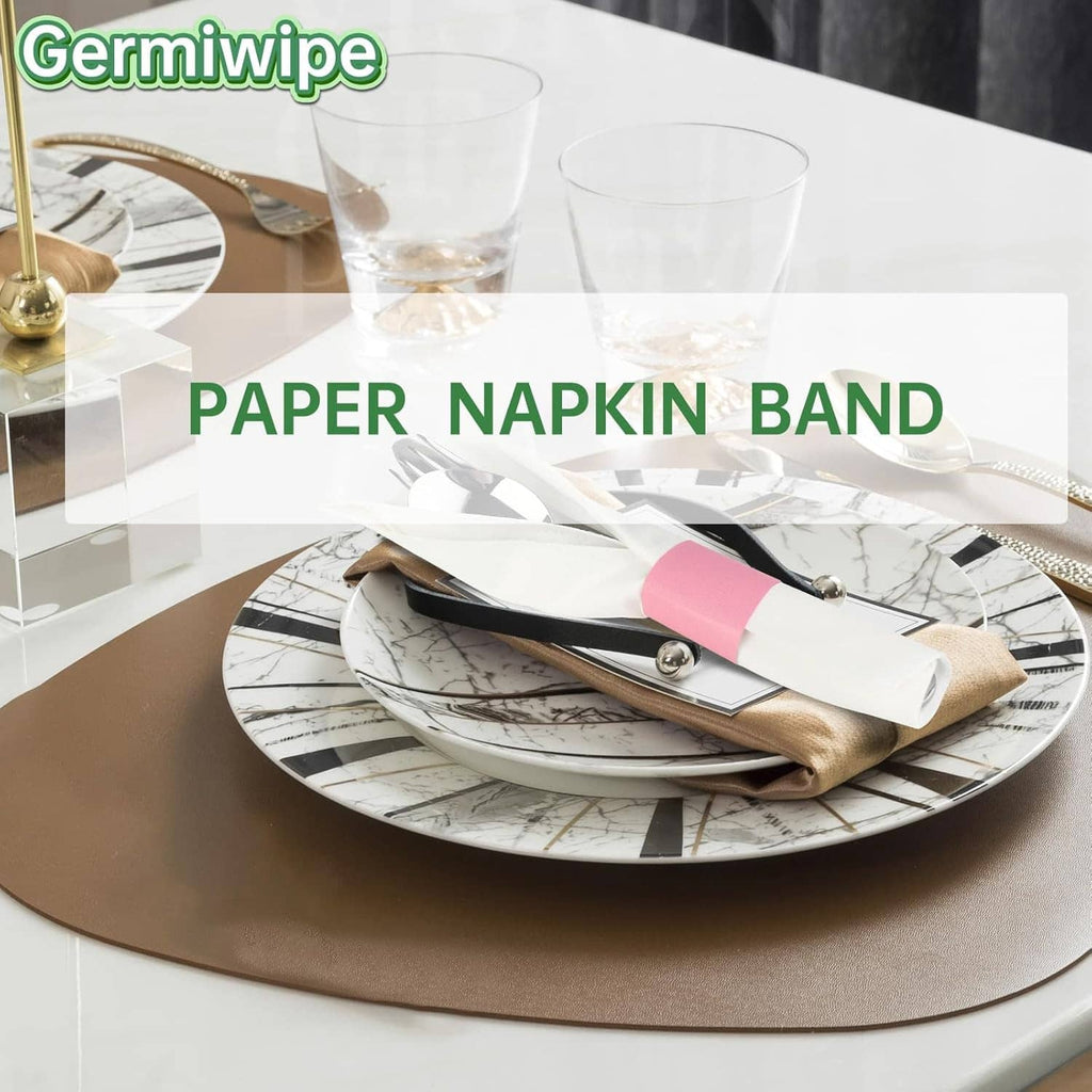 Pink paper napkin band securing wrapped cutlery on a dinner plate