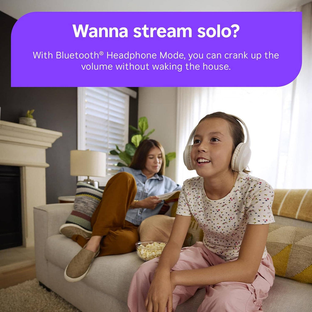 Child holding Roku voice remote while using TV in living room