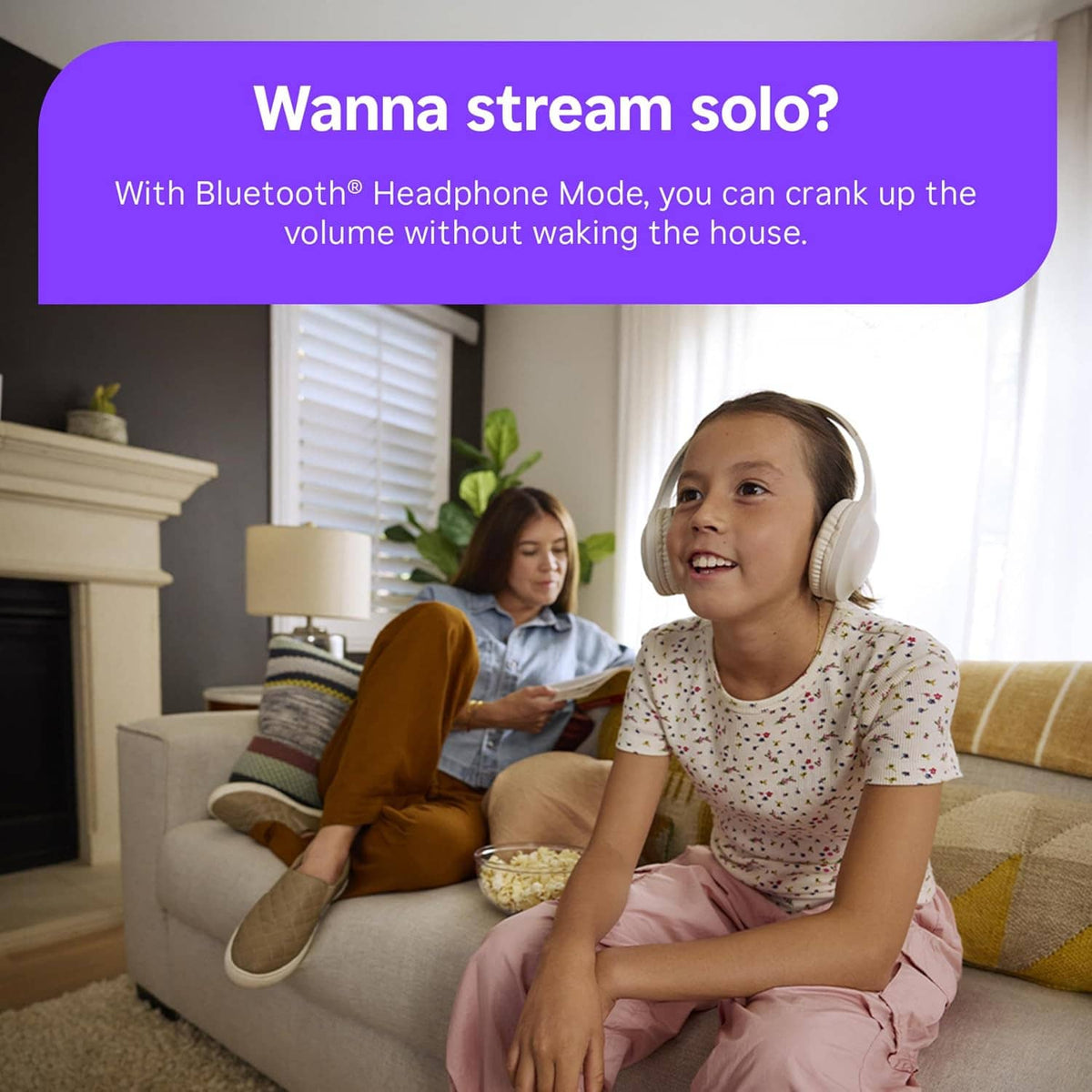 Child holding Roku voice remote while using TV in living room