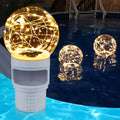 Pool chlorine floater with glowing warm-white solar ball light, floating in water