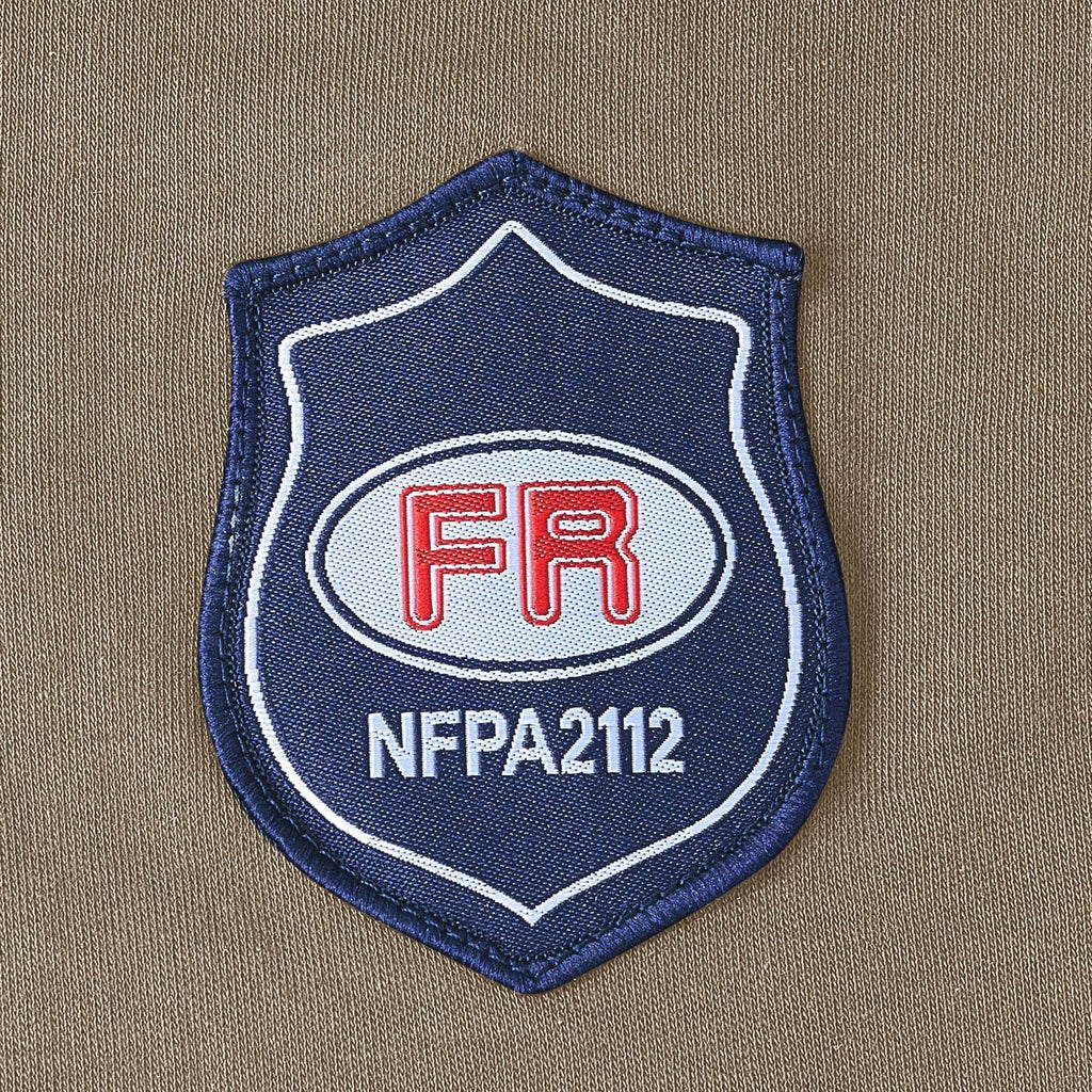 Flame-resistant work shirt FR NFPA 2112 shield patch on gray fabric