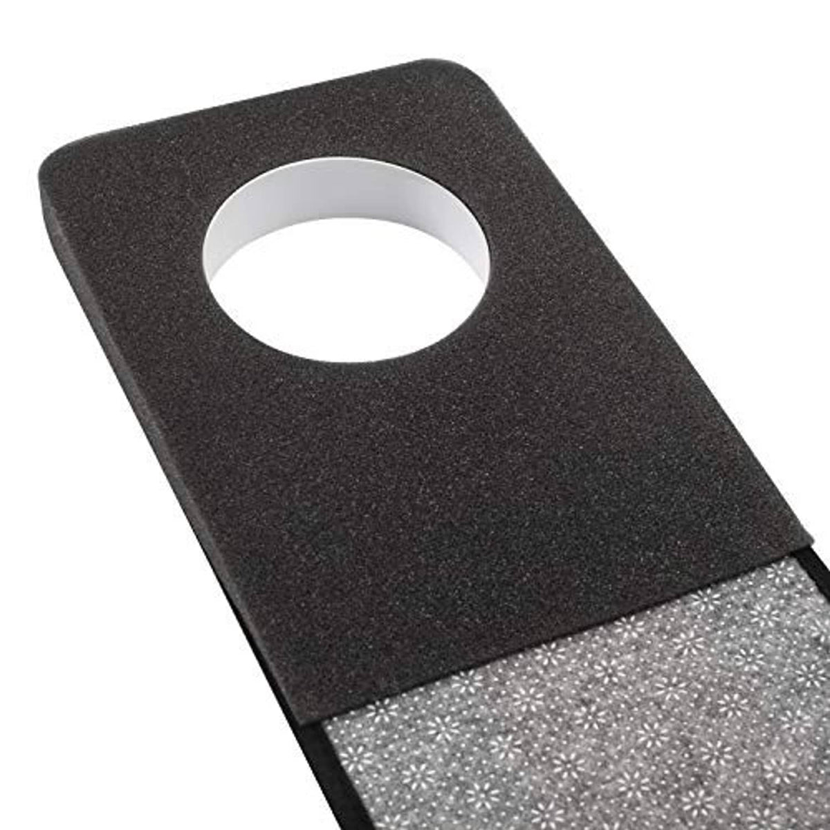 Golf putting mat corner with black border and round white cup opening.