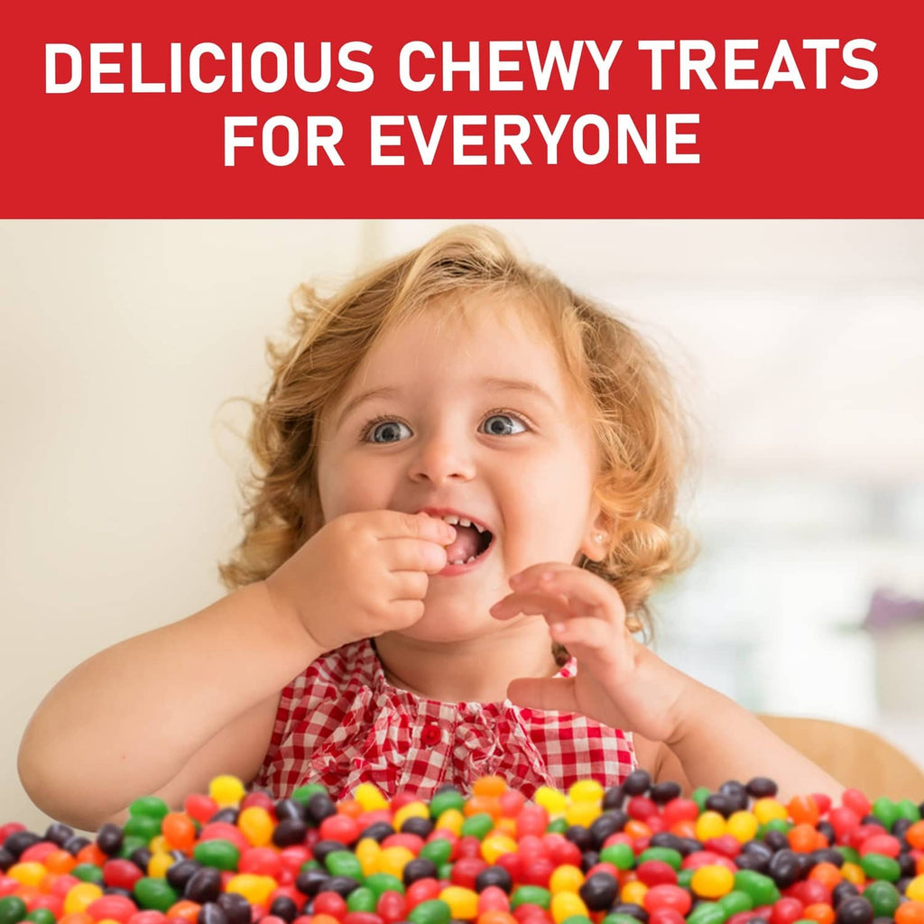Child holding a handful of colorful jelly beans