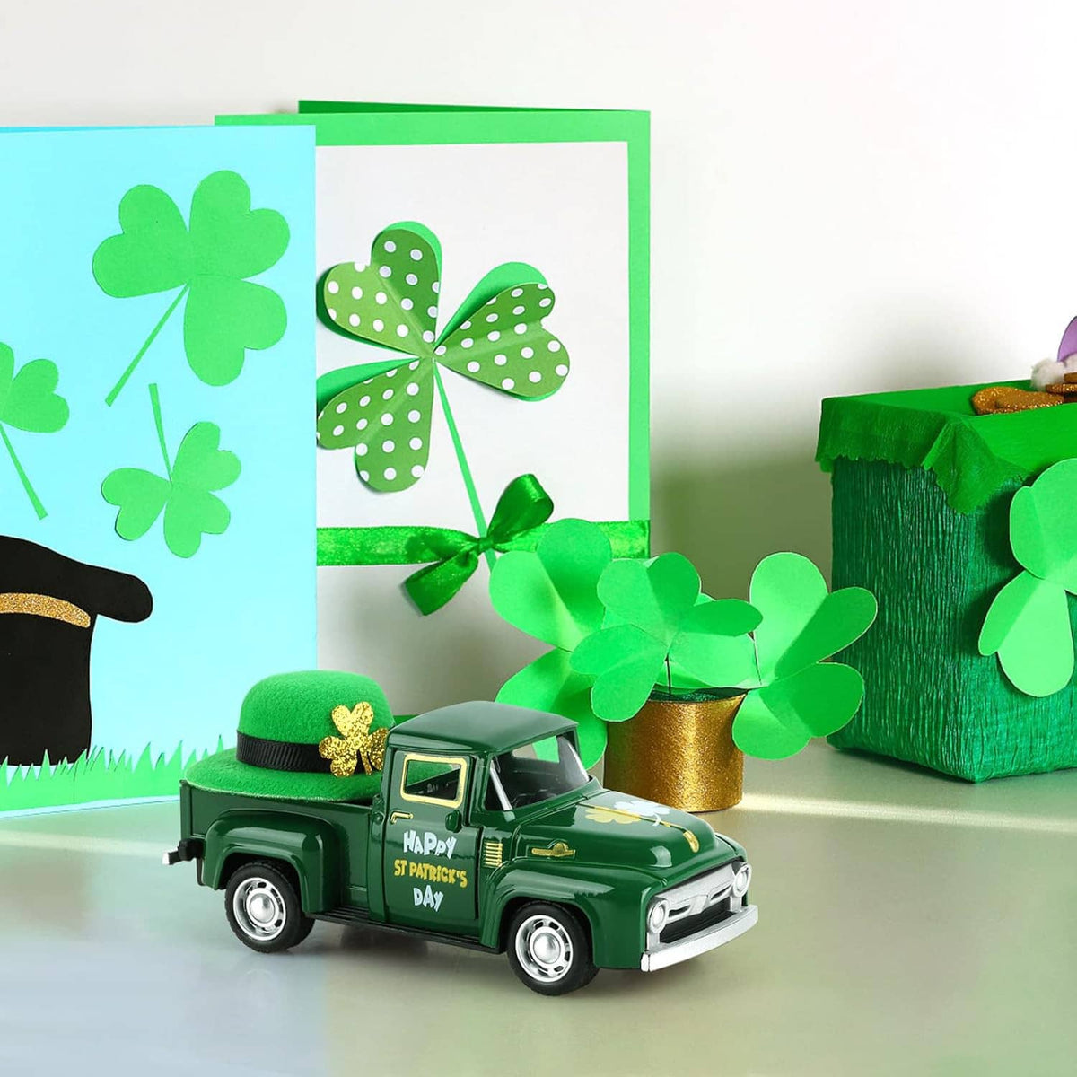 Green mini die-cast pickup with St. Patrick's Day print and green hat on table