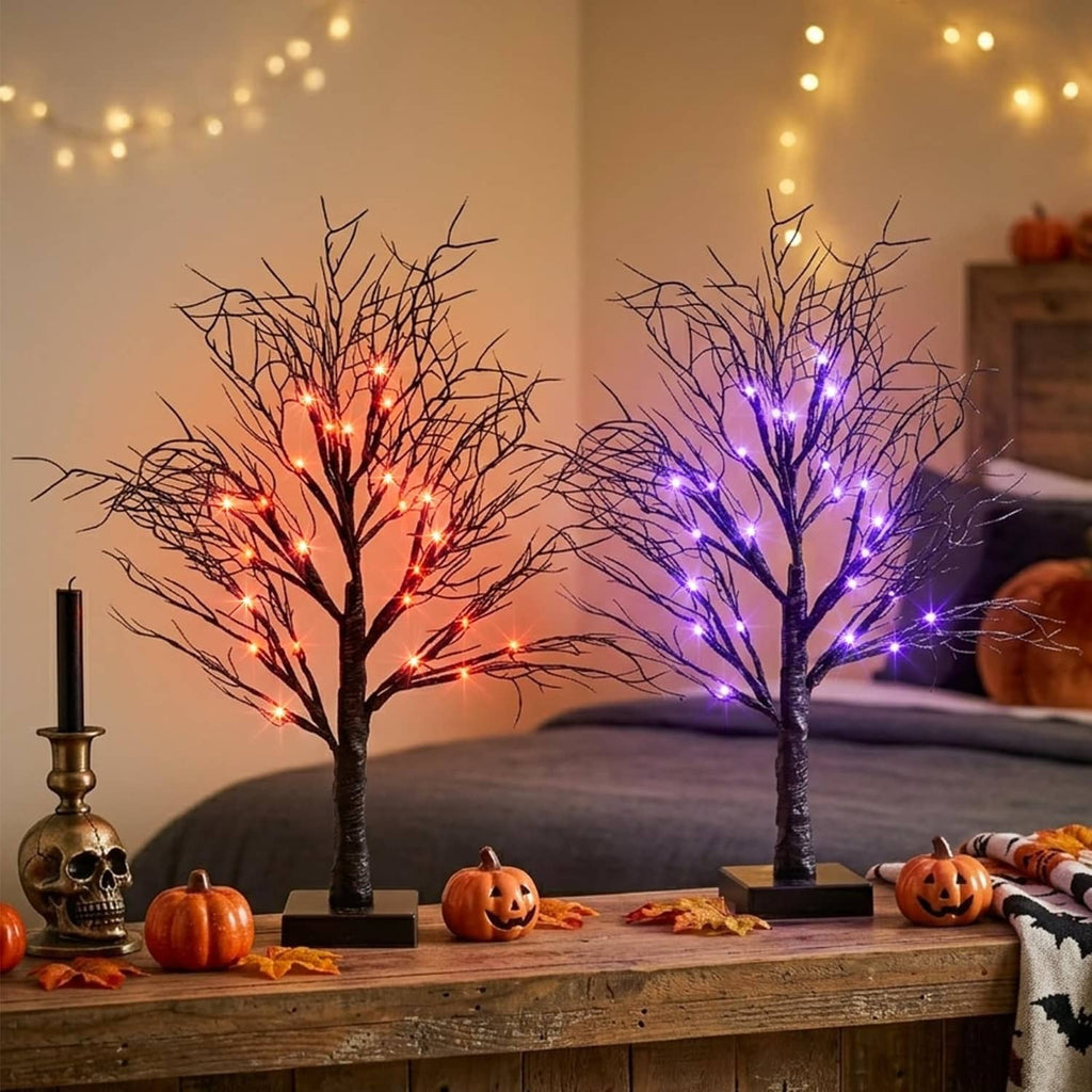 Halloween LED light trees on wooden mantle, orange and purple lit branches