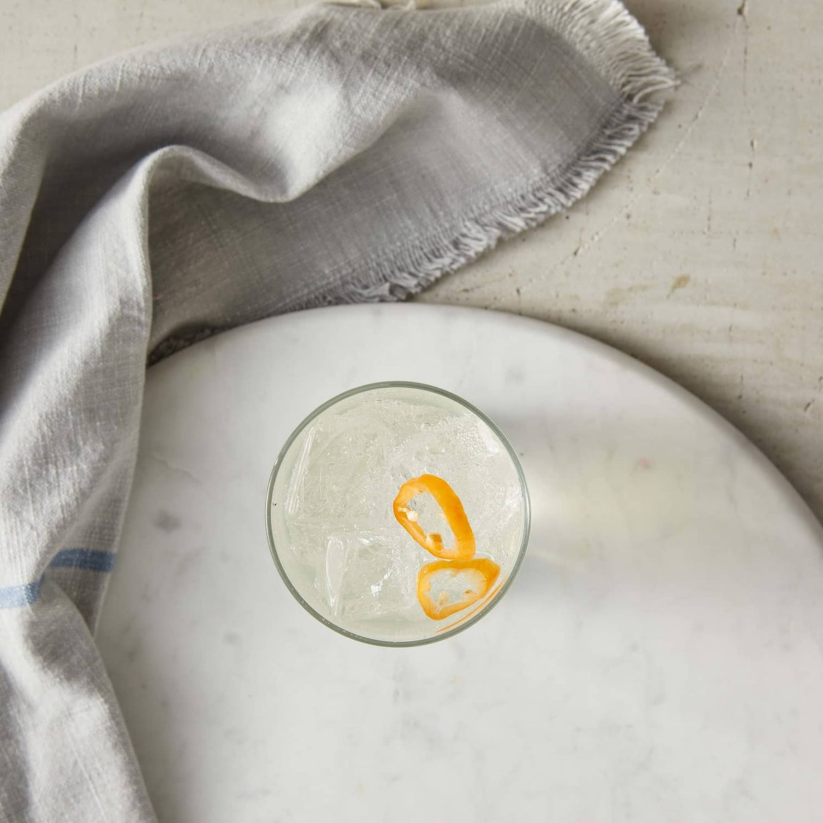 Habanero pepper garnish floating in a clear chilled syrup drink