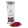 Crystal award-winning saffron threads in a white jar with silver lid and red strands