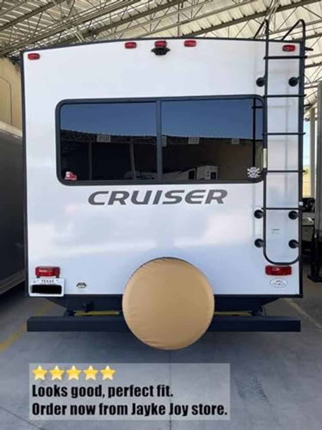 Beige spare tire cover on a vehicle back door, circular fitted cover.