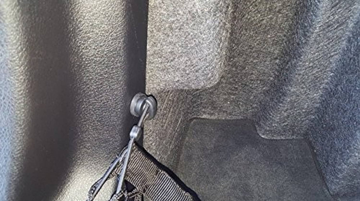 Cargo net attachment hook with chain secured inside the cargo area
