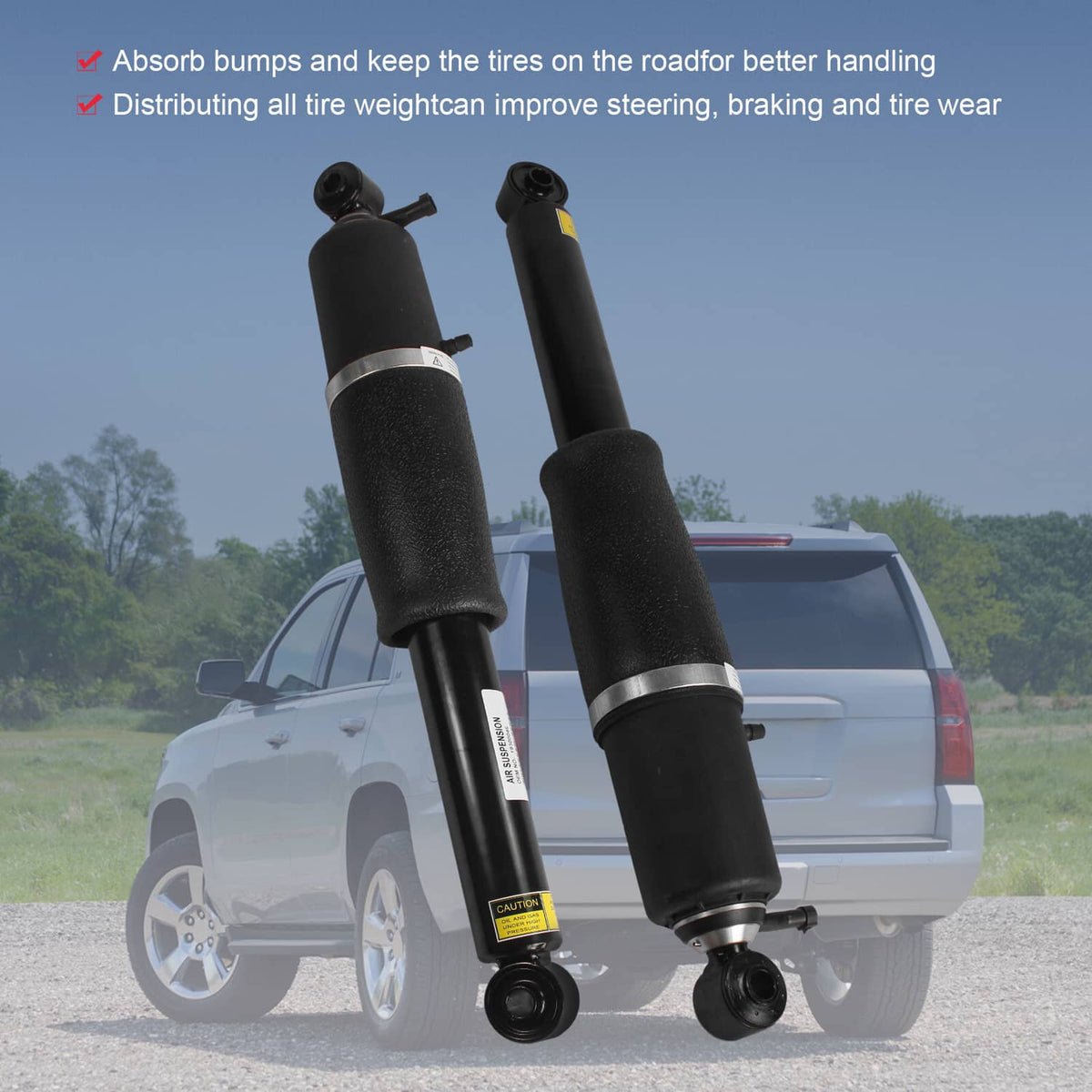 Two black air strut shock absorbers positioned beside a rear SUV.