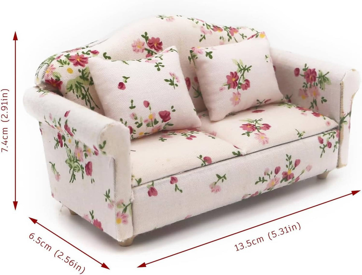 Floral miniature loveseat sofa; tufted cushions on off-white base, about 7.4 cm tall