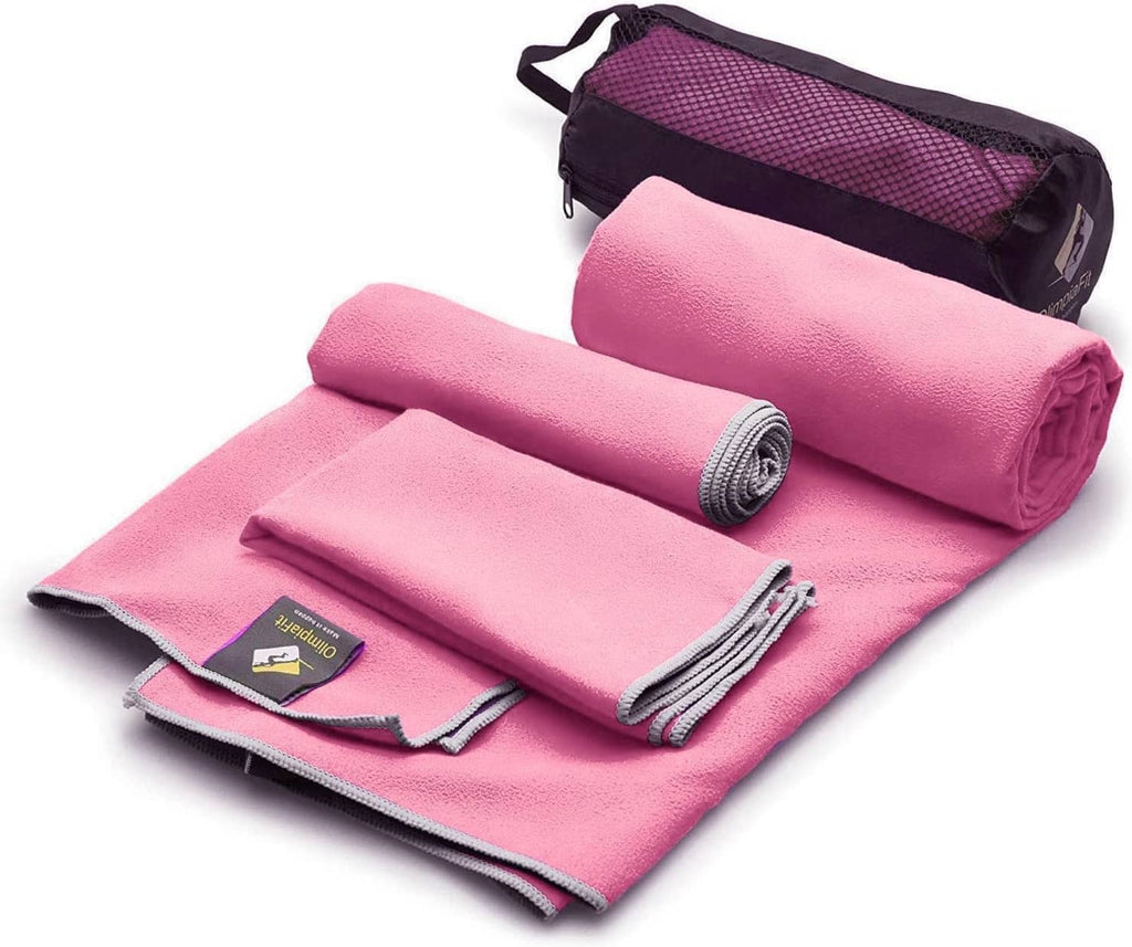 Pink microfiber towel set with rolled towels and matching storage bag