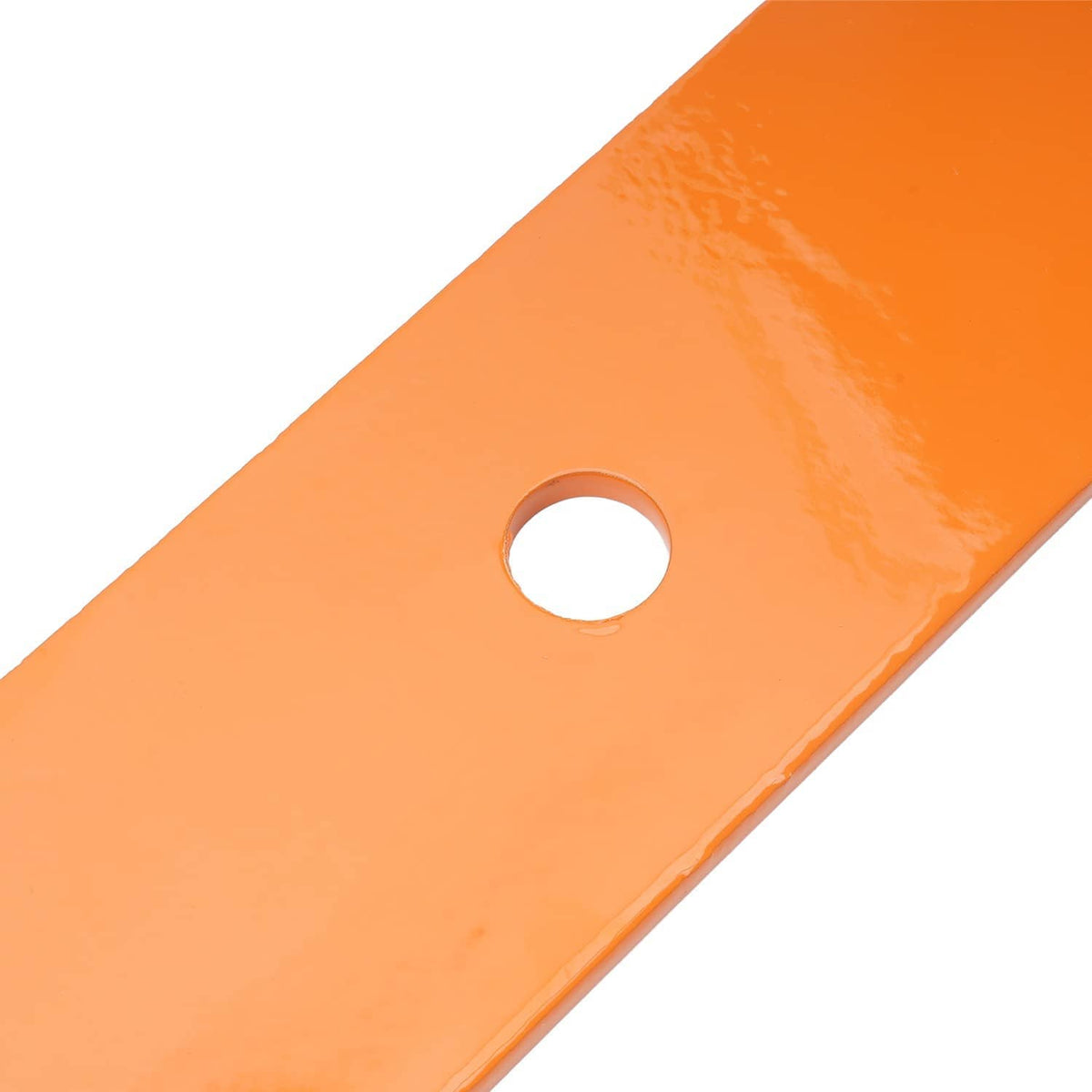 Orange mower deck blade corner with round mounting hole, close-up