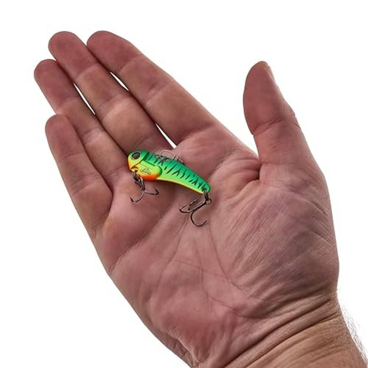 Berkley Thinfisher blade bait lure held in hand, green and yellow Firetiger with treble hooks
