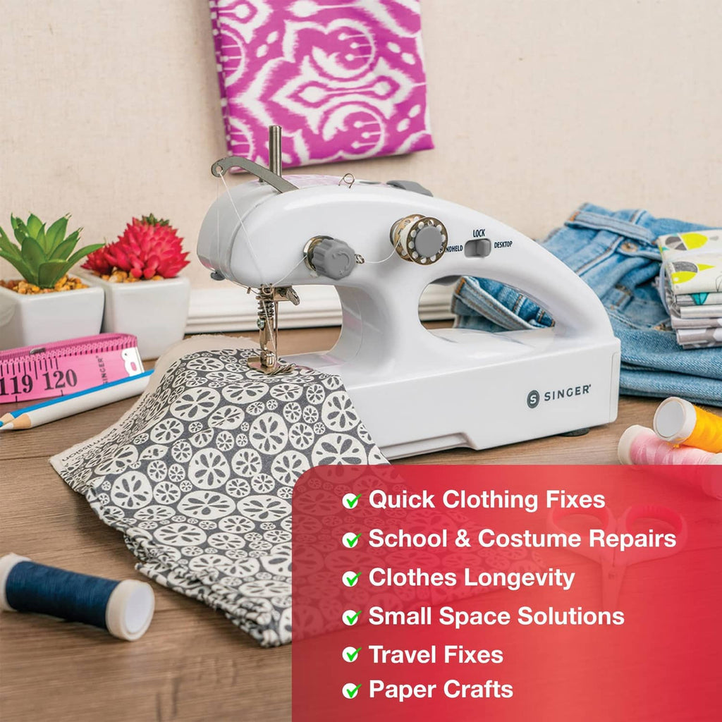 White cordless mending machine with accessories on a crafting table