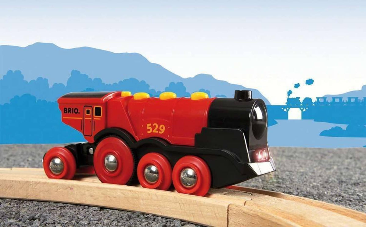 Red and black toy locomotive with 5 red wheels and yellow light domes