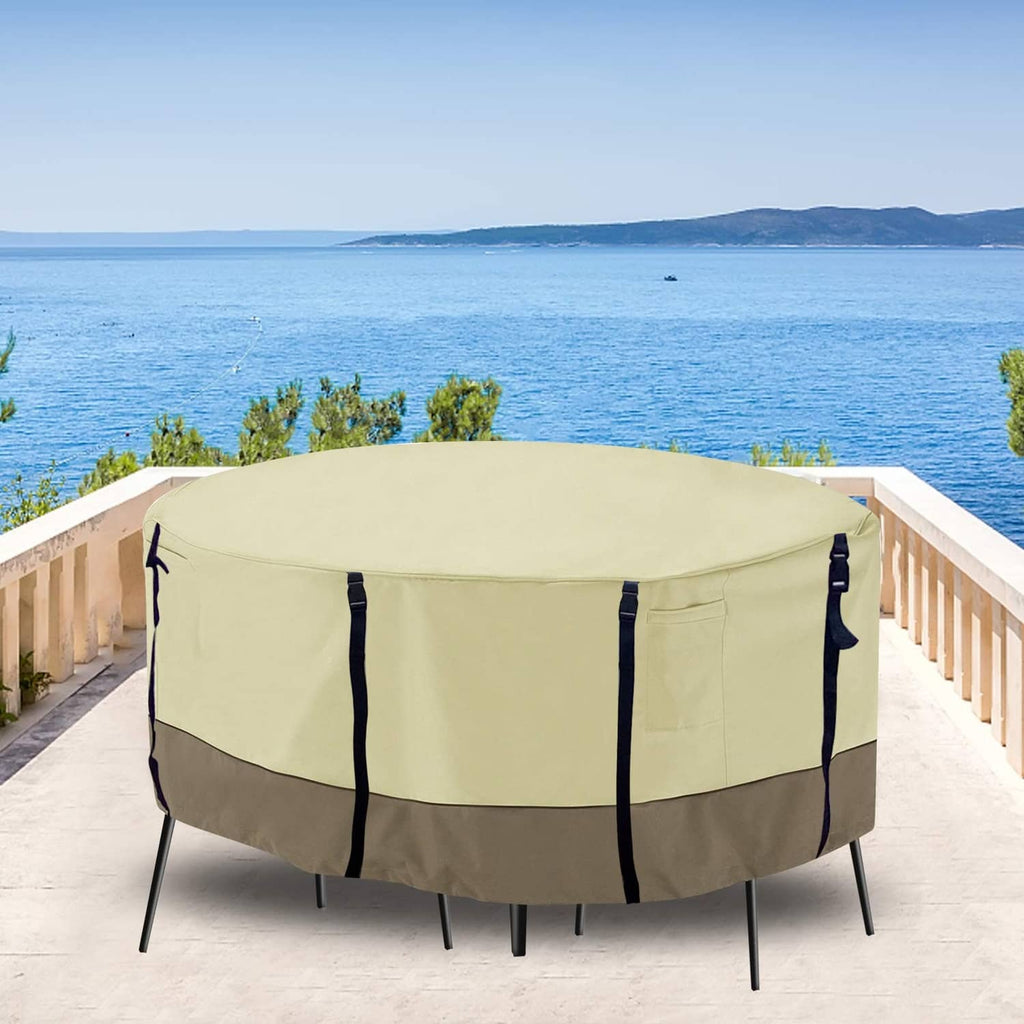 Beige round patio furniture cover with four securing straps, snug wrap fit