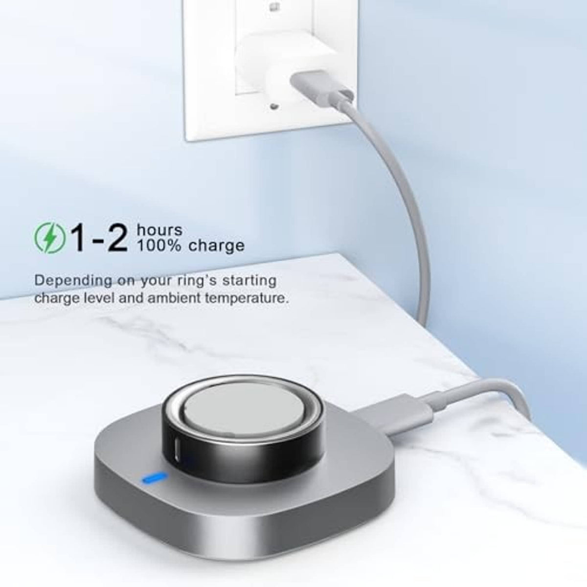 Ring charging dock with cable plugged in, dark silver base and blue LED status light