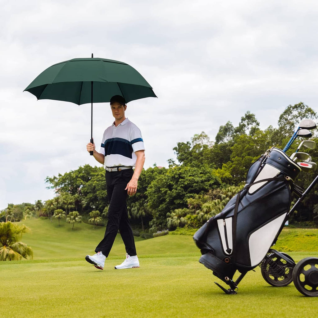 Dark green 62-inch golf umbrella open next to a golf bag